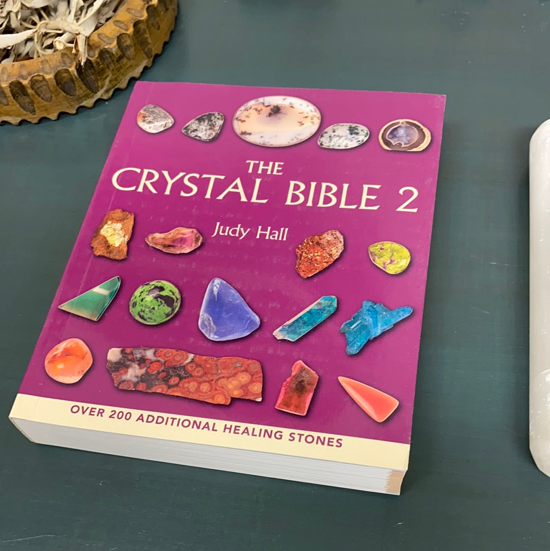 The Crystal Bible 2, a beautifully illustrated guide featuring various crystals with detailed descriptions and full-color photographs.