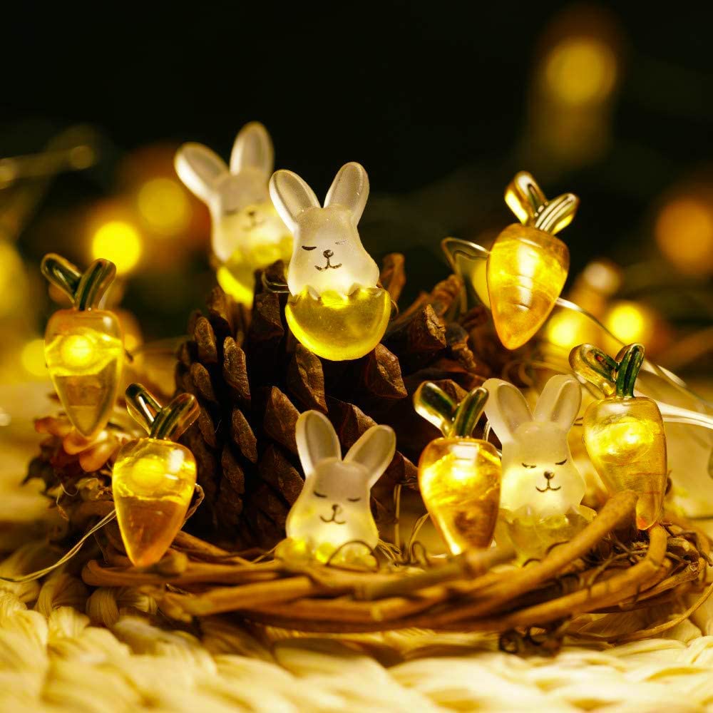 A string of cute Easter lights featuring bunnies and carrots, glowing warmly in a festive outdoor setting.