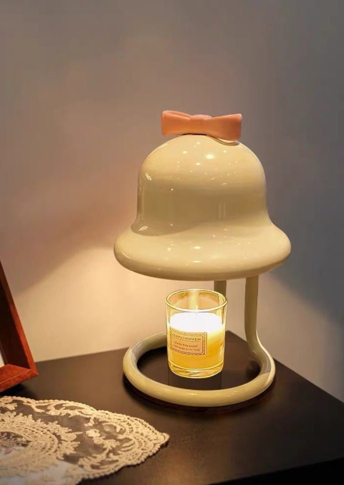 Cute whimsical bell candle warmer lamp designed for large candles, featuring a playful bell shape and warm light.