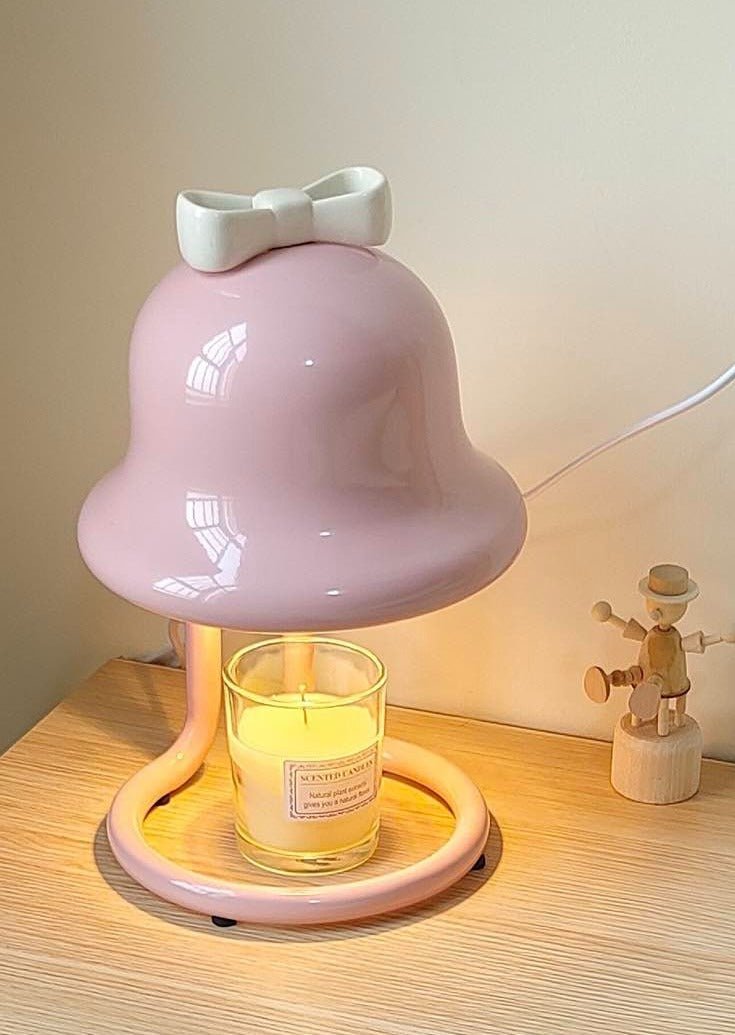 Cute whimsical bell candle warmer lamp designed for large candles, featuring a playful bell shape and warm light.