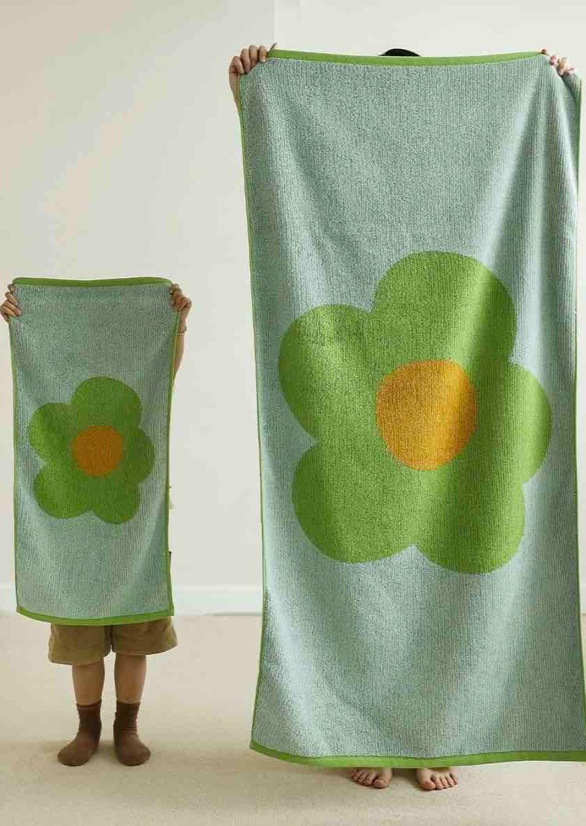 Cute Whimsical Sunflower Bath Towel featuring vibrant sunflower prints on soft cotton fabric.