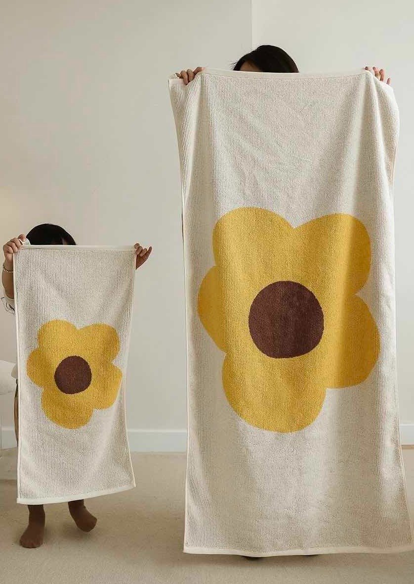 Cute Whimsical Sunflower Bath Towel featuring vibrant sunflower prints on soft cotton fabric.