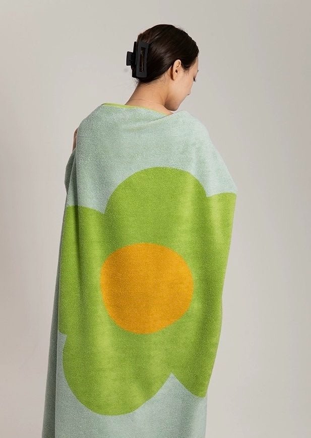 Cute Whimsical Sunflower Bath Towel featuring vibrant sunflower prints on soft cotton fabric.