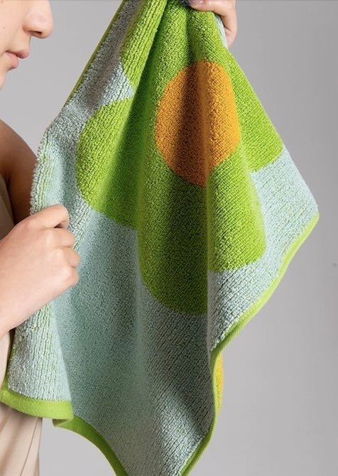 Cute Whimsical Sunflower Bath Towel featuring vibrant sunflower prints on soft cotton fabric.