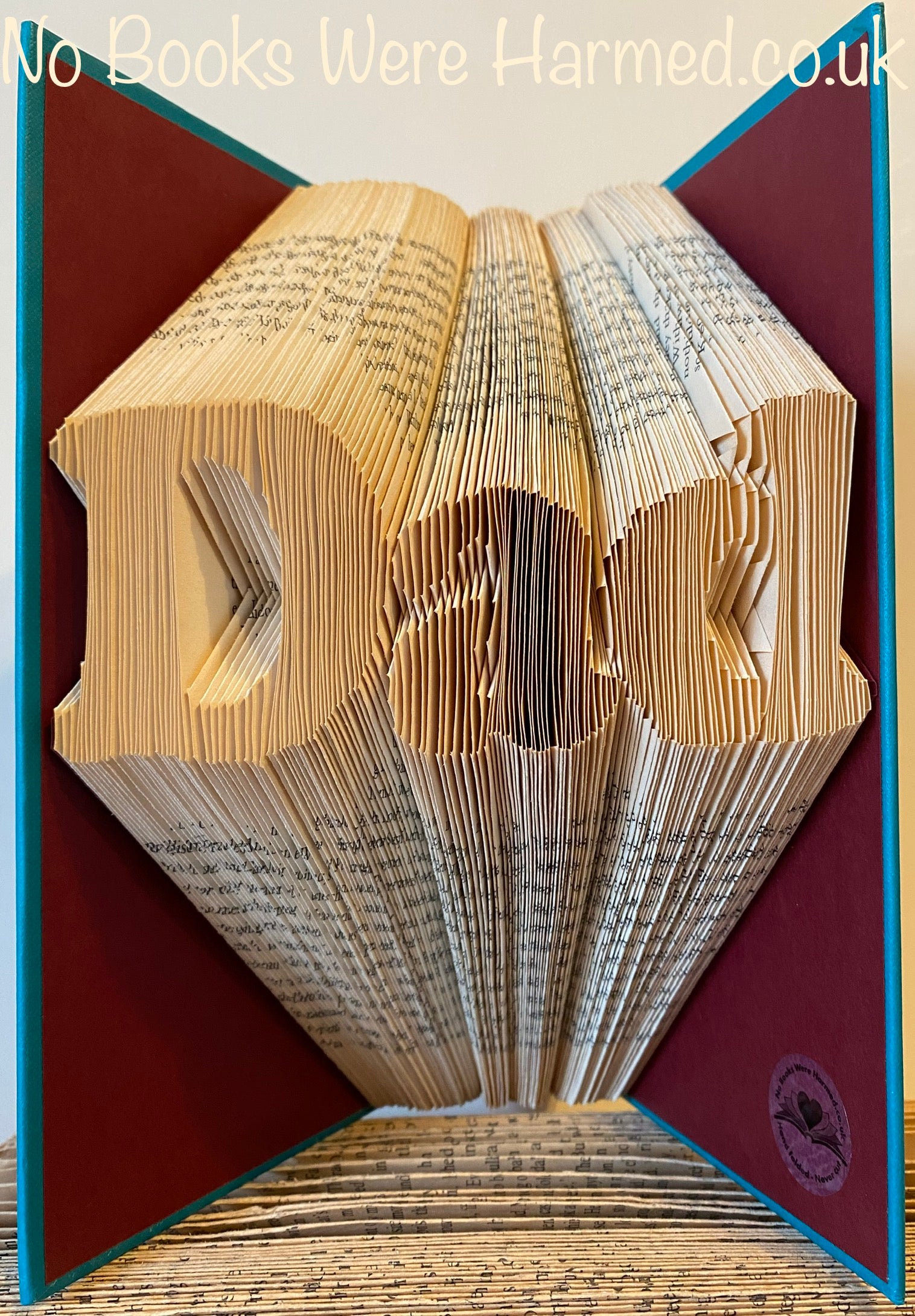 Hand-folded book art made from vintage books, showcasing intricate designs and unique craftsmanship.