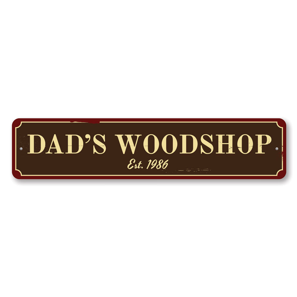 A decorative Dad's Woodshop Sign made of high-quality aluminum, featuring customizable text and pre-drilled holes for easy mounting.