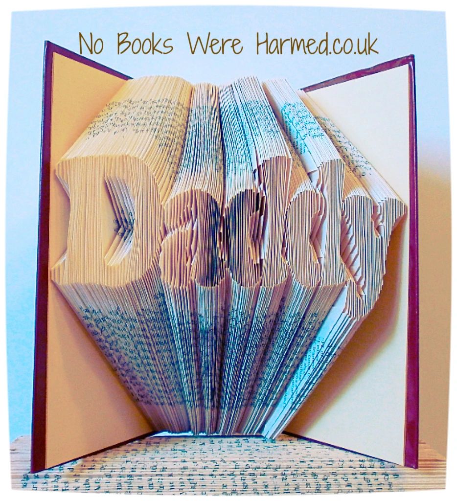 Handcrafted 'Daddy' art piece made from vintage books, showcasing unique folded pages and intricate design.