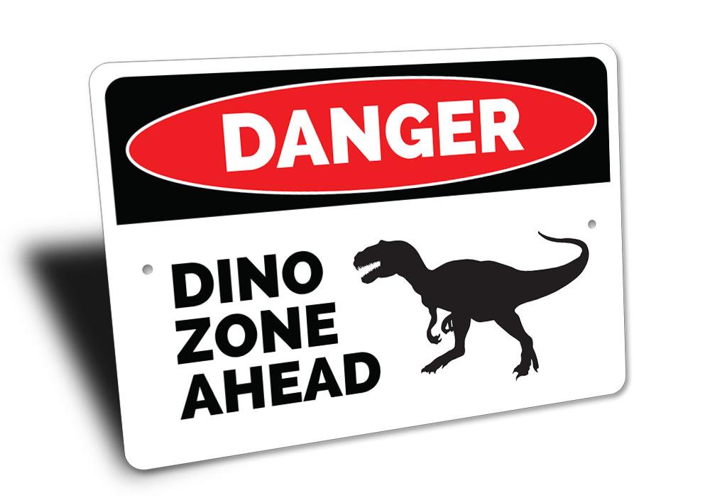 A colorful Danger Dino Zone Ahead Sign featuring playful dinosaur graphics, perfect for children's rooms.