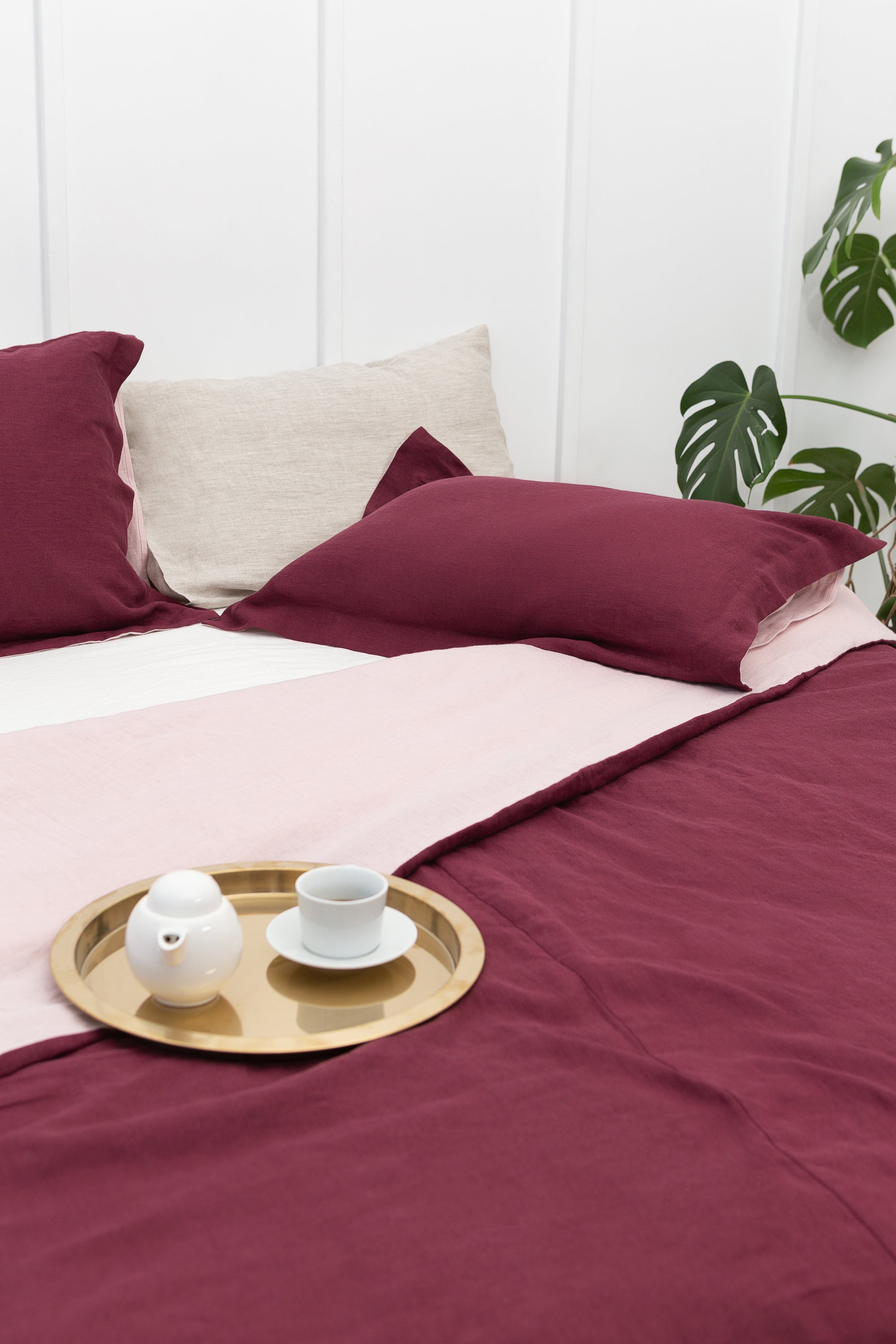 Dark Plum and Pale Pink double-sided linen bedding set featuring a duvet cover, fitted sheet, and pillowcases with coconut buttons.