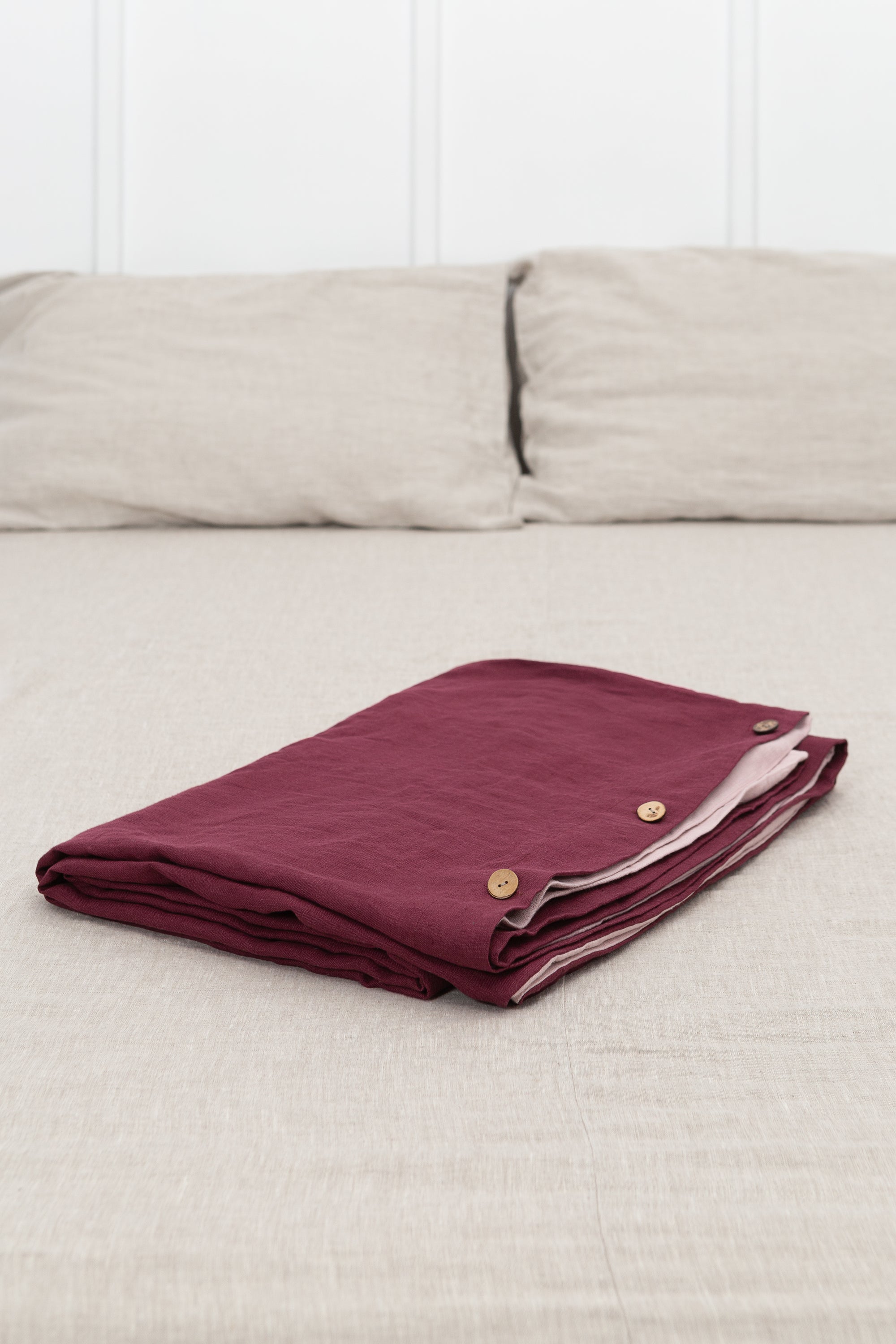 Dark Plum and Pale Pink double-sided linen bedding set featuring a duvet cover, fitted sheet, and pillowcases with coconut buttons.