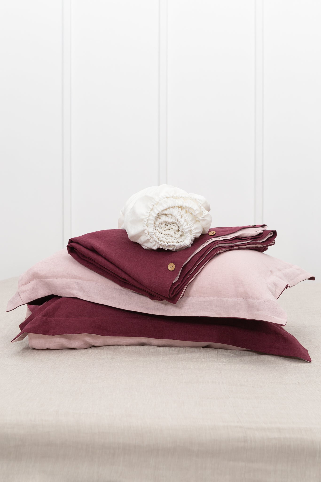 Dark Plum and Pale Pink double-sided linen bedding set featuring a duvet cover, fitted sheet, and pillowcases with coconut buttons.