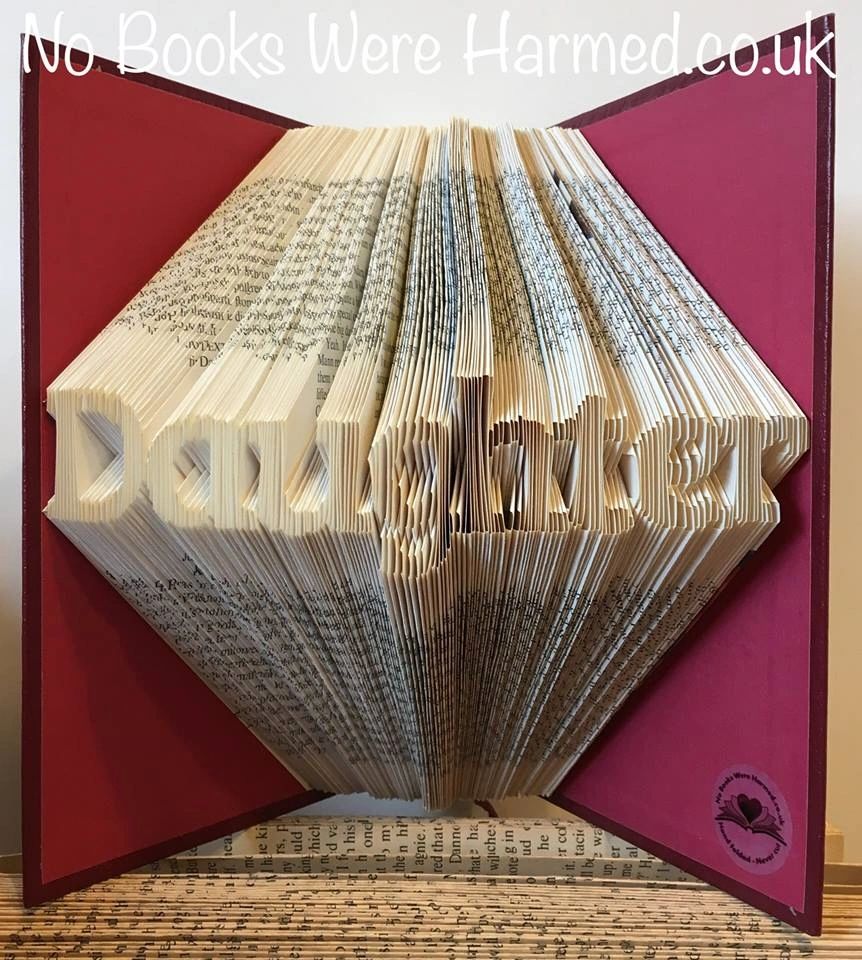 Hand-folded book art titled 'Daughter', showcasing intricate folds and unique colors from vintage books.