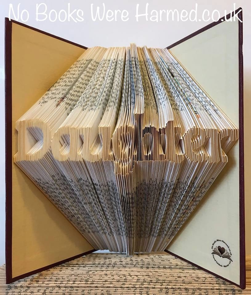 Hand-folded book art titled 'Daughter', showcasing intricate folds and unique colors from vintage books.