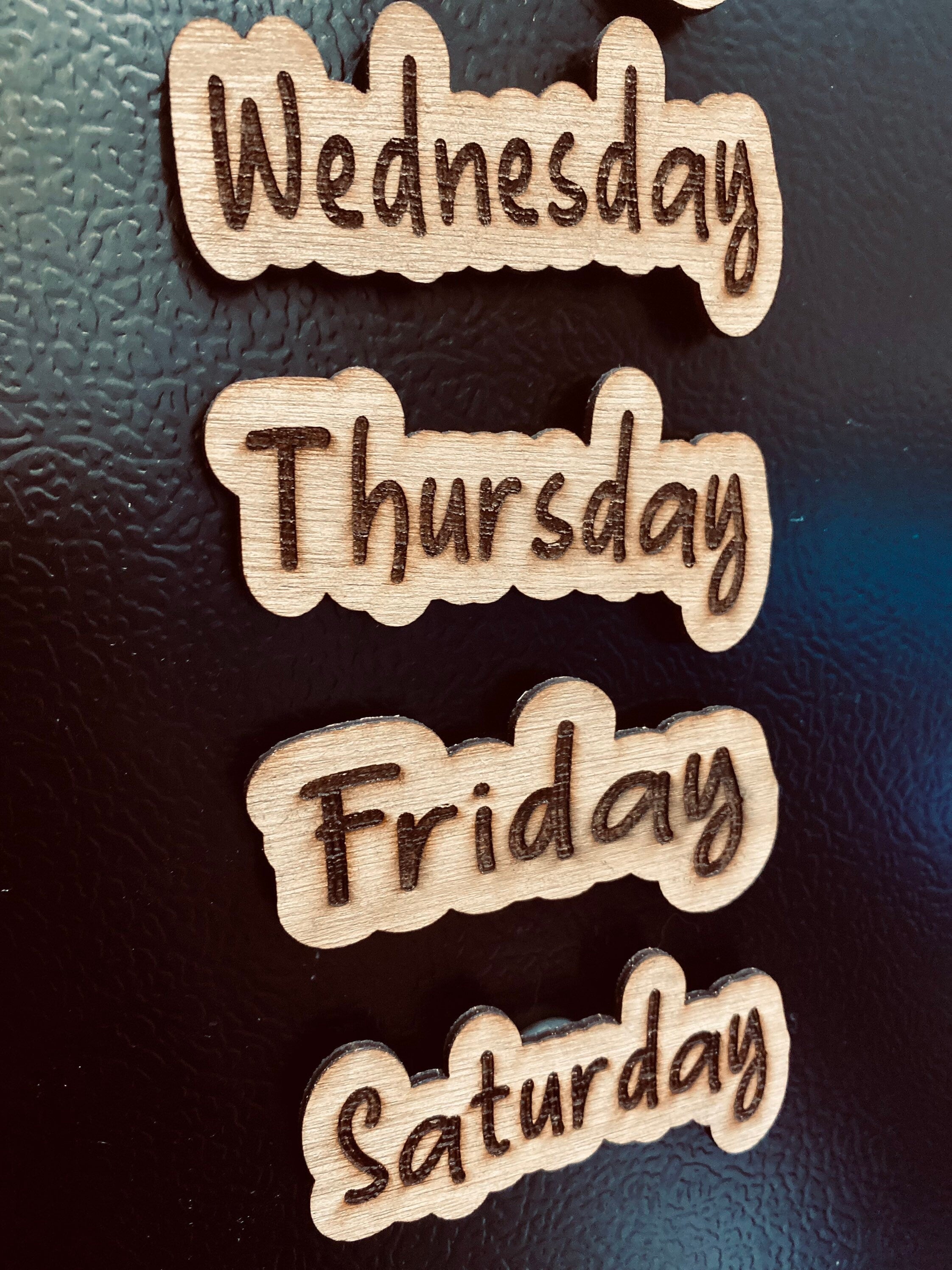 Set of wooden Days of the Week Magnets displayed on a fridge, showcasing their natural finish and laser engraved design.