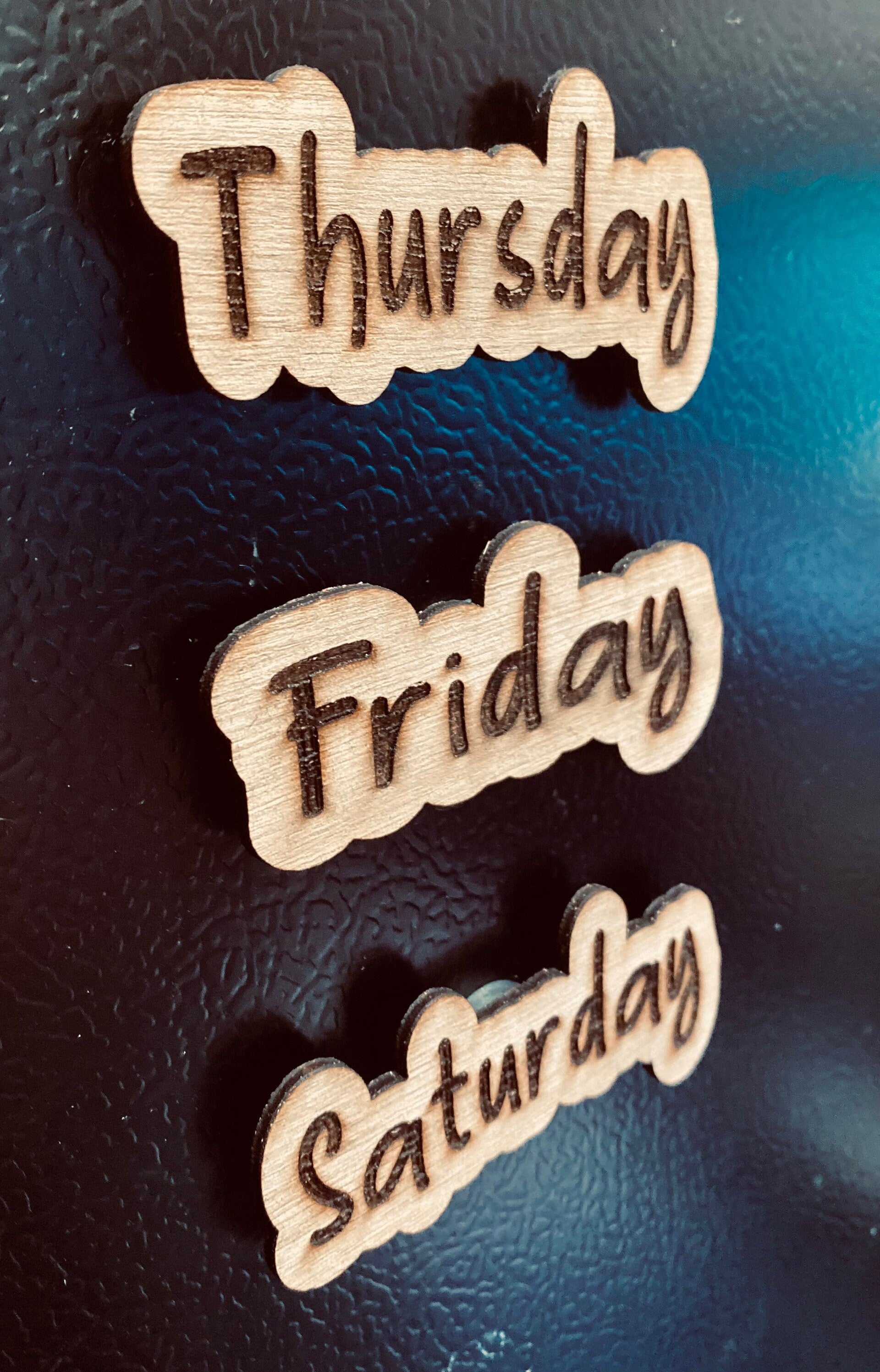 Set of wooden Days of the Week Magnets displayed on a fridge, showcasing their natural finish and laser engraved design.