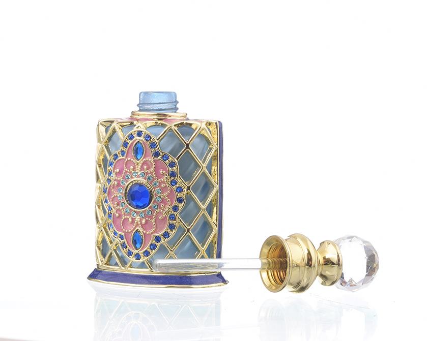 A beautifully decorated perfume bottle with enamel painting and Austrian crystals, showcasing intricate craftsmanship and luxurious gold plating.