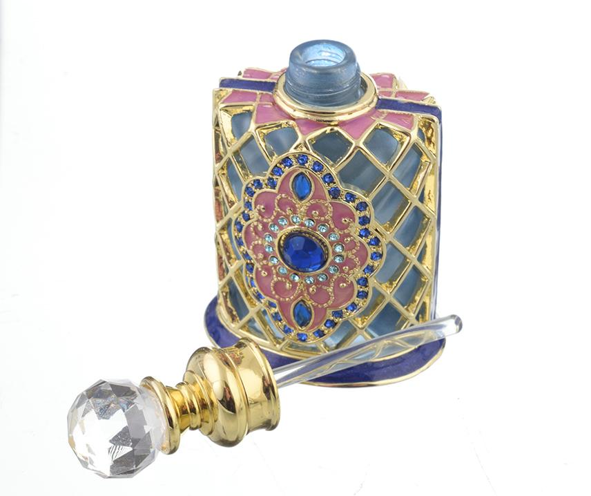 A beautifully decorated perfume bottle with enamel painting and Austrian crystals, showcasing intricate craftsmanship and luxurious gold plating.