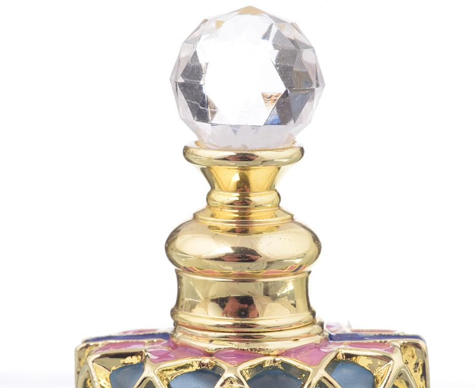 A beautifully decorated perfume bottle with enamel painting and Austrian crystals, showcasing intricate craftsmanship and luxurious gold plating.