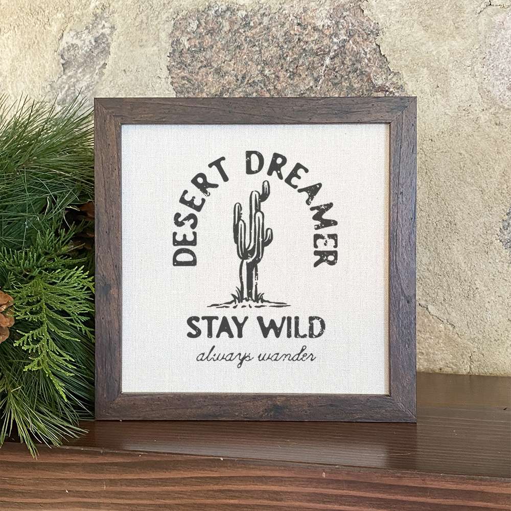 Desert Dreamer framed sign with a stylized wood frame and linen-look background, perfect for home decor.