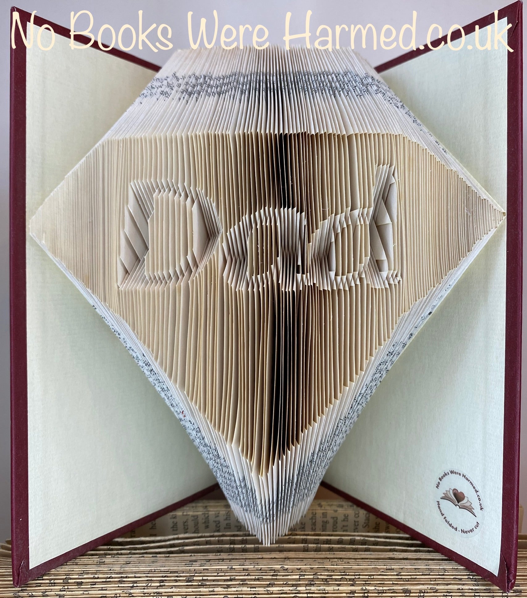 Handcrafted Diamond Dad art piece made from vintage books, showcasing intricate page folds and unique design.