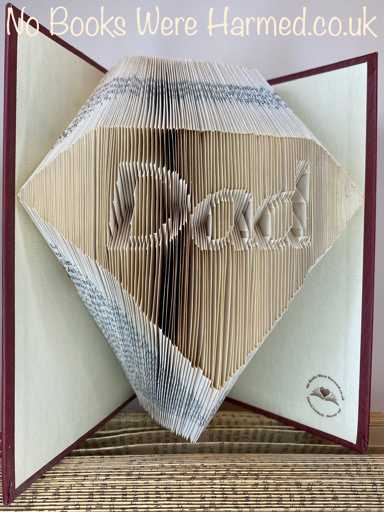 Handcrafted Diamond Dad art piece made from vintage books, showcasing intricate page folds and unique design.