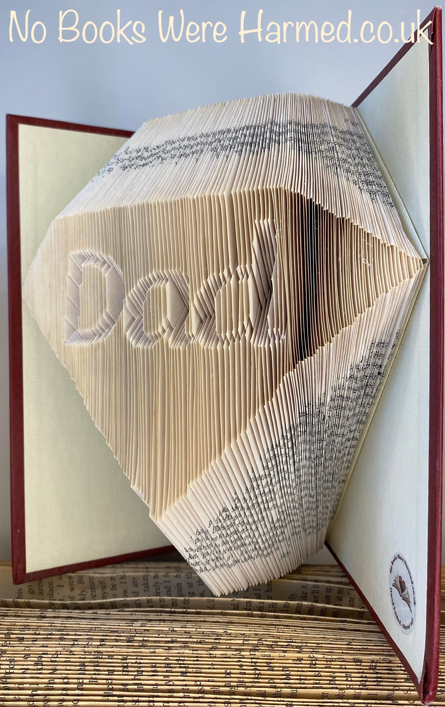 Handcrafted Diamond Dad art piece made from vintage books, showcasing intricate page folds and unique design.