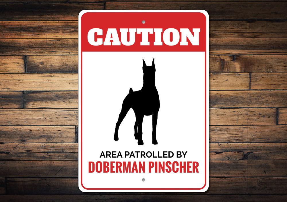 A decorative Doberman Pinscher sign made of high-quality aluminum, featuring a customizable design, perfect for home decor.