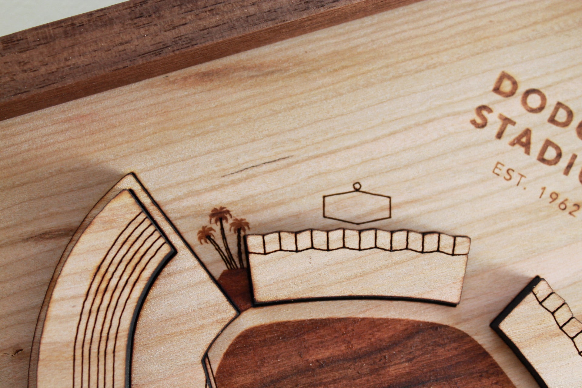 A detailed wooden replica of Dodger Stadium featuring palm trees and a black walnut frame, perfect for Dodgers fans.