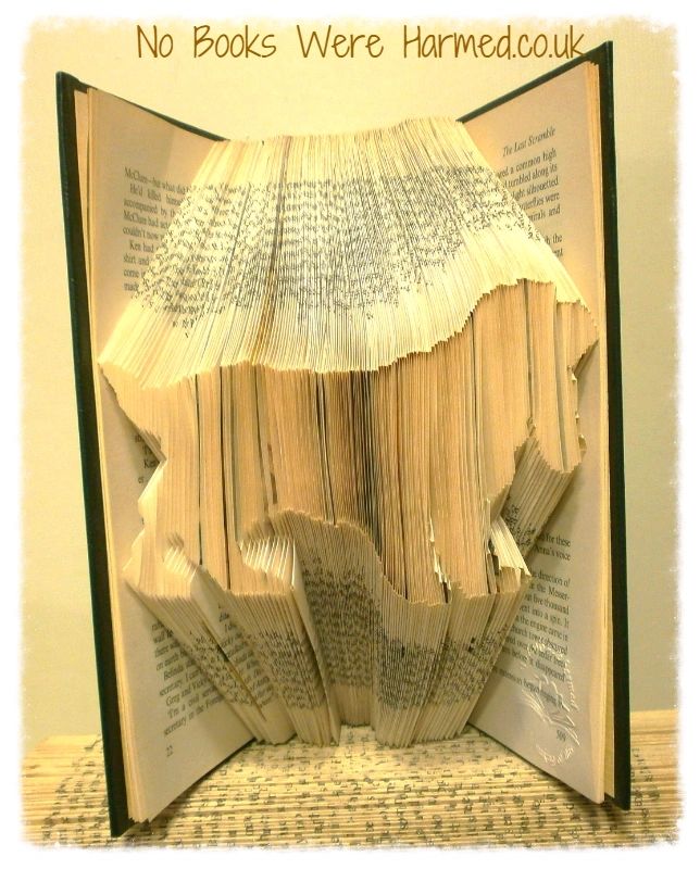 Handcrafted dog silhouette art made from vintage book pages, showcasing intricate details and unique designs.