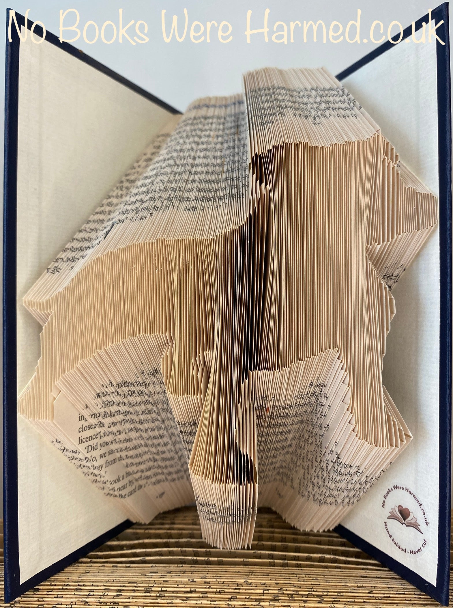 Handcrafted dog silhouette art made from vintage book pages, showcasing intricate details and unique designs.