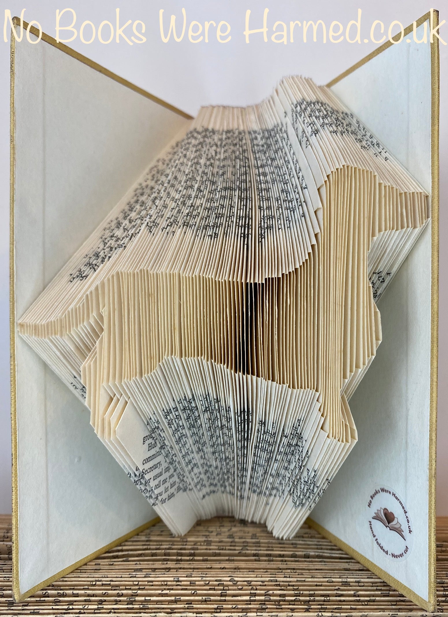 Handcrafted dog silhouette art made from vintage book pages, showcasing intricate details and unique designs.