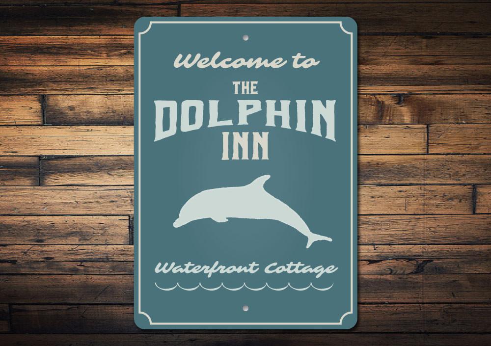 Dolphin Inn Sign featuring vibrant coastal design, made from high-quality aluminum, perfect for beach-themed decor.