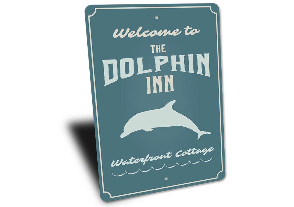 Dolphin Inn Sign featuring vibrant coastal design, made from high-quality aluminum, perfect for beach-themed decor.