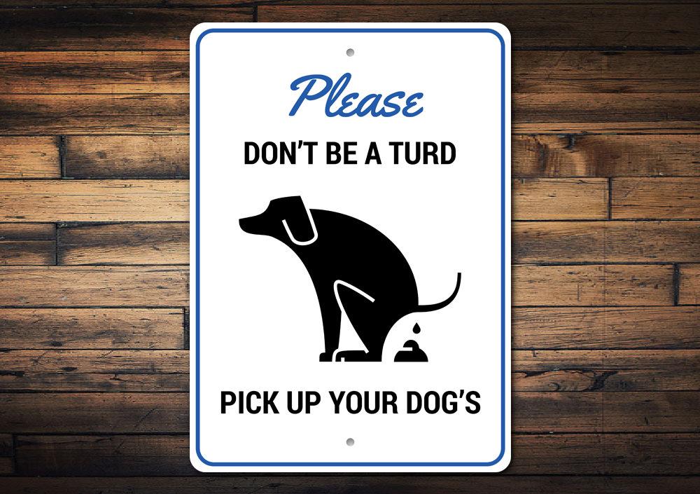 A humorous 'Don't Be a Turd' decorative sign made of aluminum, featuring a playful design suitable for home decor.