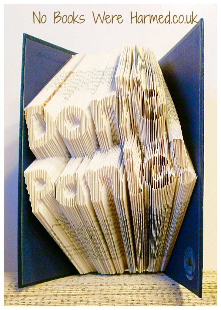 Art piece titled 'Don't Panic!' made from hand-folded pages of vintage books, showcasing unique craftsmanship and eco-friendly design.