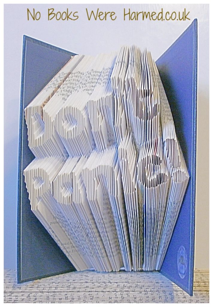 Art piece titled 'Don't Panic!' made from hand-folded pages of vintage books, showcasing unique craftsmanship and eco-friendly design.