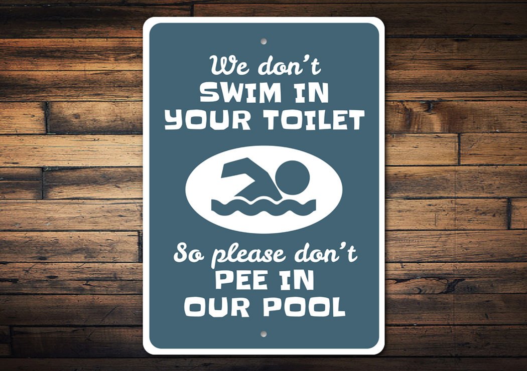 A humorous Don't Pee in the Pool Sign made of durable aluminum, featuring bold text and a colorful design, perfect for poolside decoration.