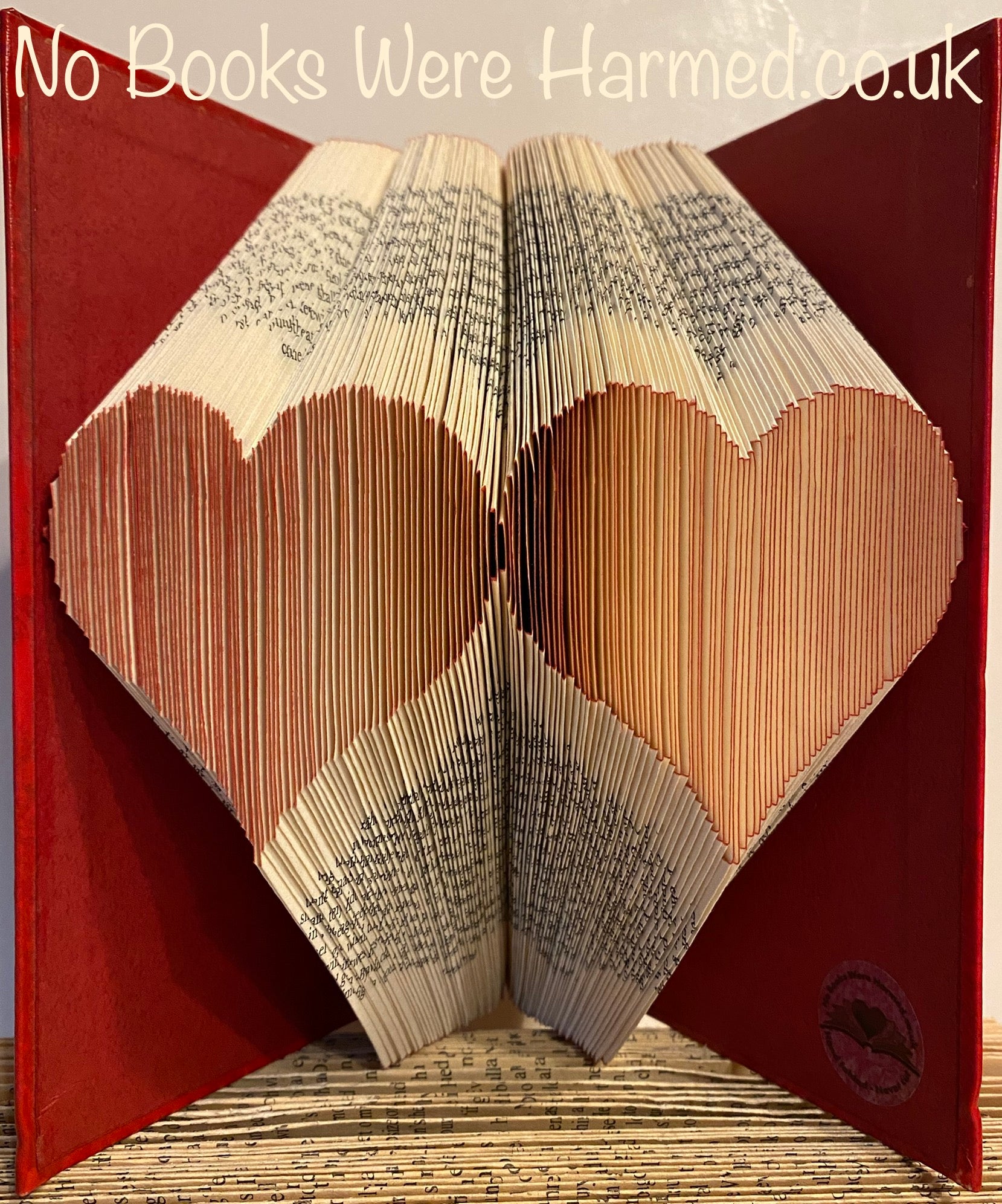 Handcrafted Double Two Hearts art piece made from vintage book pages, showcasing intricate folds and unique design.