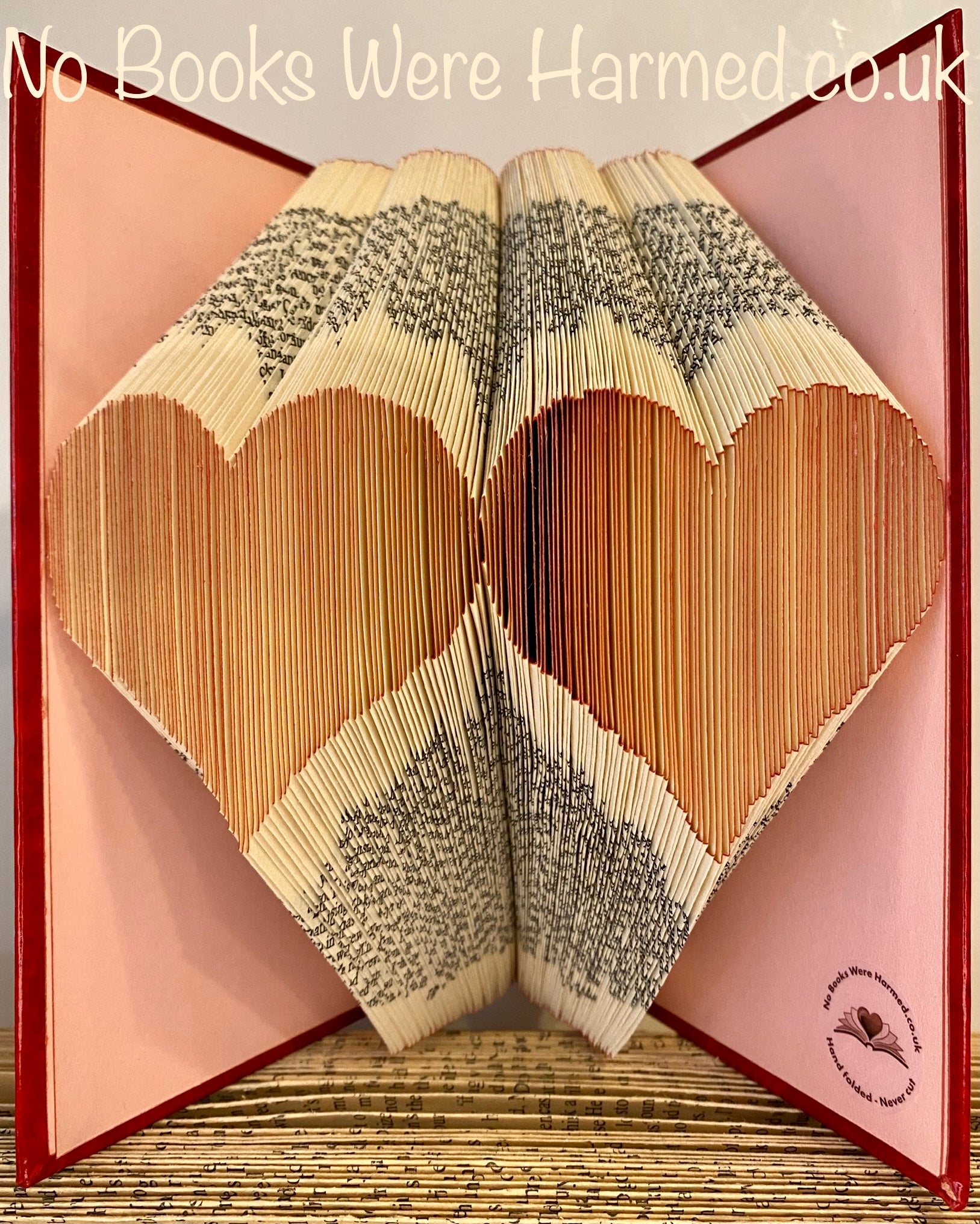 Handcrafted Double Two Hearts art piece made from vintage book pages, showcasing intricate folds and unique design.