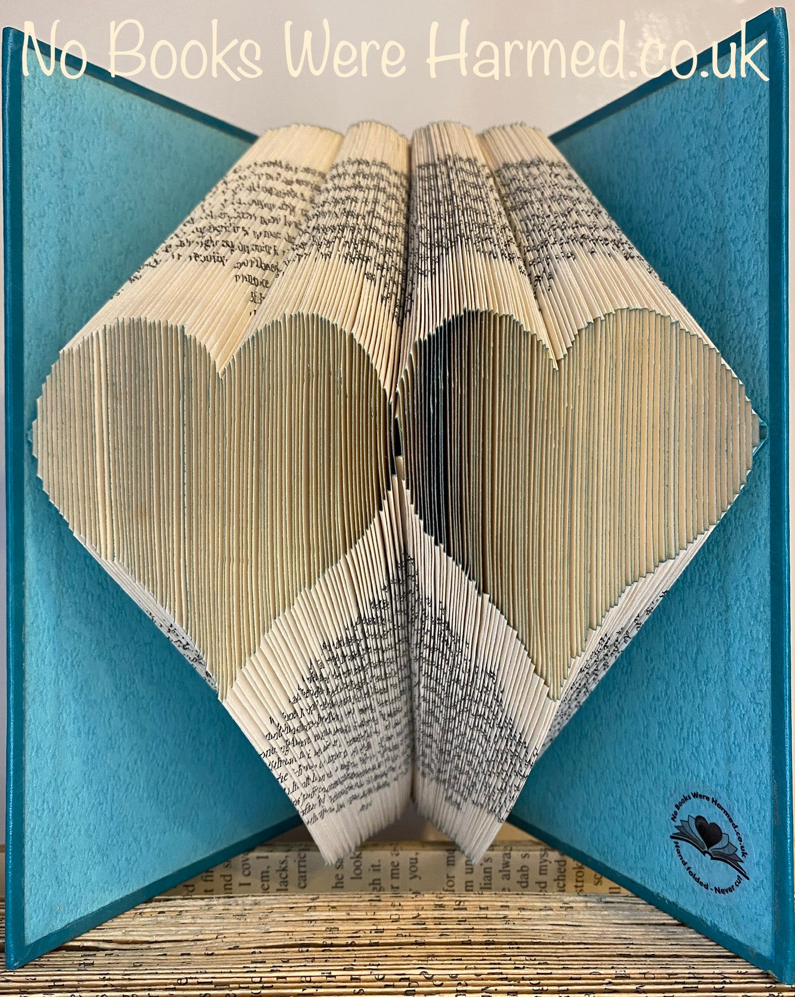 Handcrafted Double Two Hearts art piece made from vintage book pages, showcasing intricate folds and unique design.