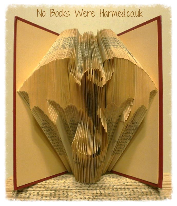 A handcrafted Dragon art piece made from folded pages of vintage books, showcasing intricate details and unique design.