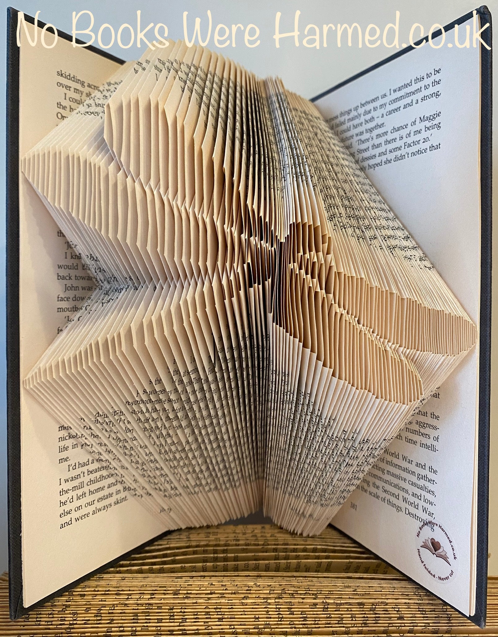 Handcrafted Dragonfly art piece made from vintage book pages, showcasing intricate folds and unique design.