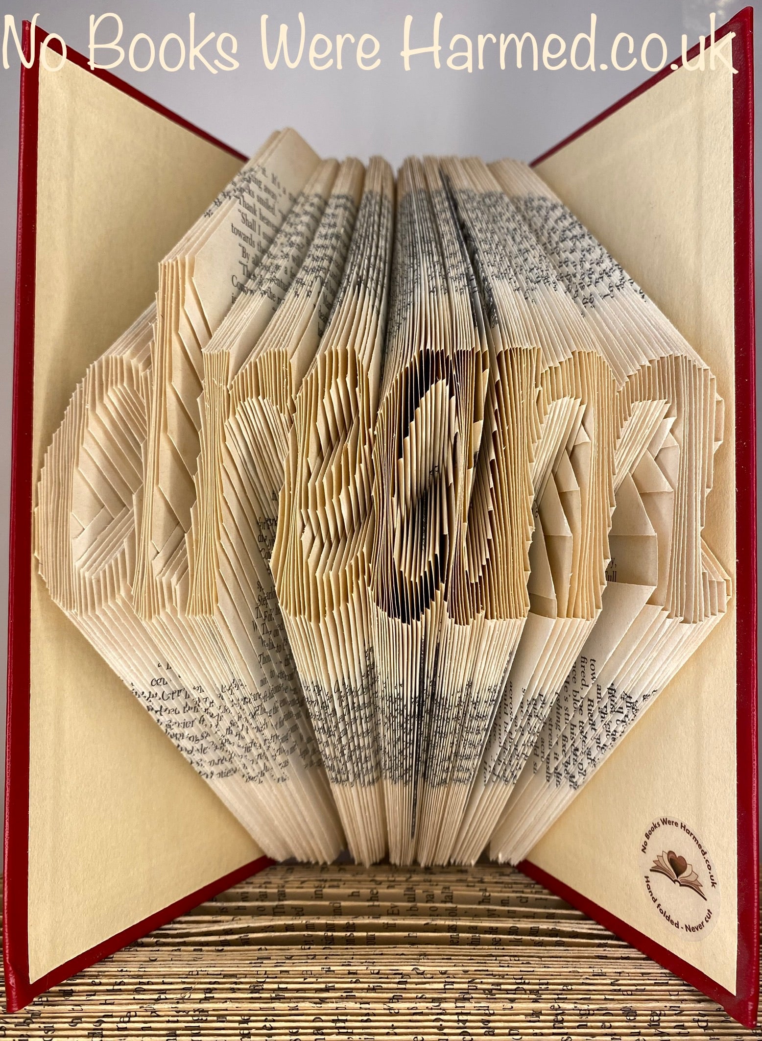 A unique piece of hand-folded book art from the Dream collection, showcasing intricate page folds and vintage book aesthetics.