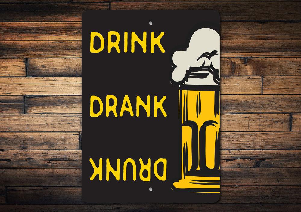 Drink Drank Drunk Beer Sign made of high-quality aluminum, featuring a humorous design perfect for man caves and kitchens.