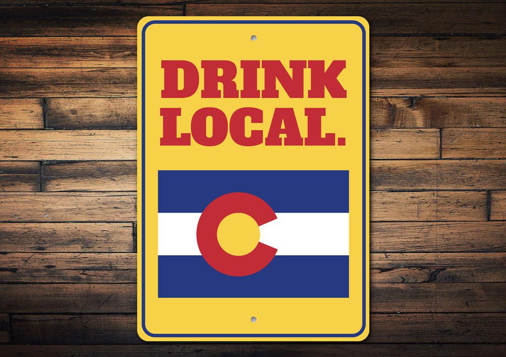 A decorative Drink Local Sign made of high-quality aluminum, featuring customizable text and pre-drilled holes for easy mounting.