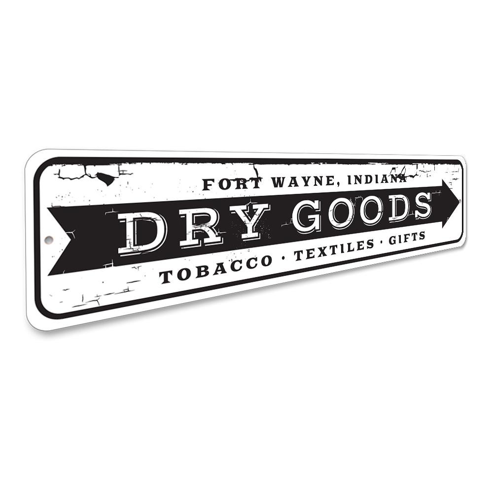 A decorative Dry Goods Arrow Sign made of high-quality aluminum, featuring customizable text and pre-drilled holes for easy mounting.