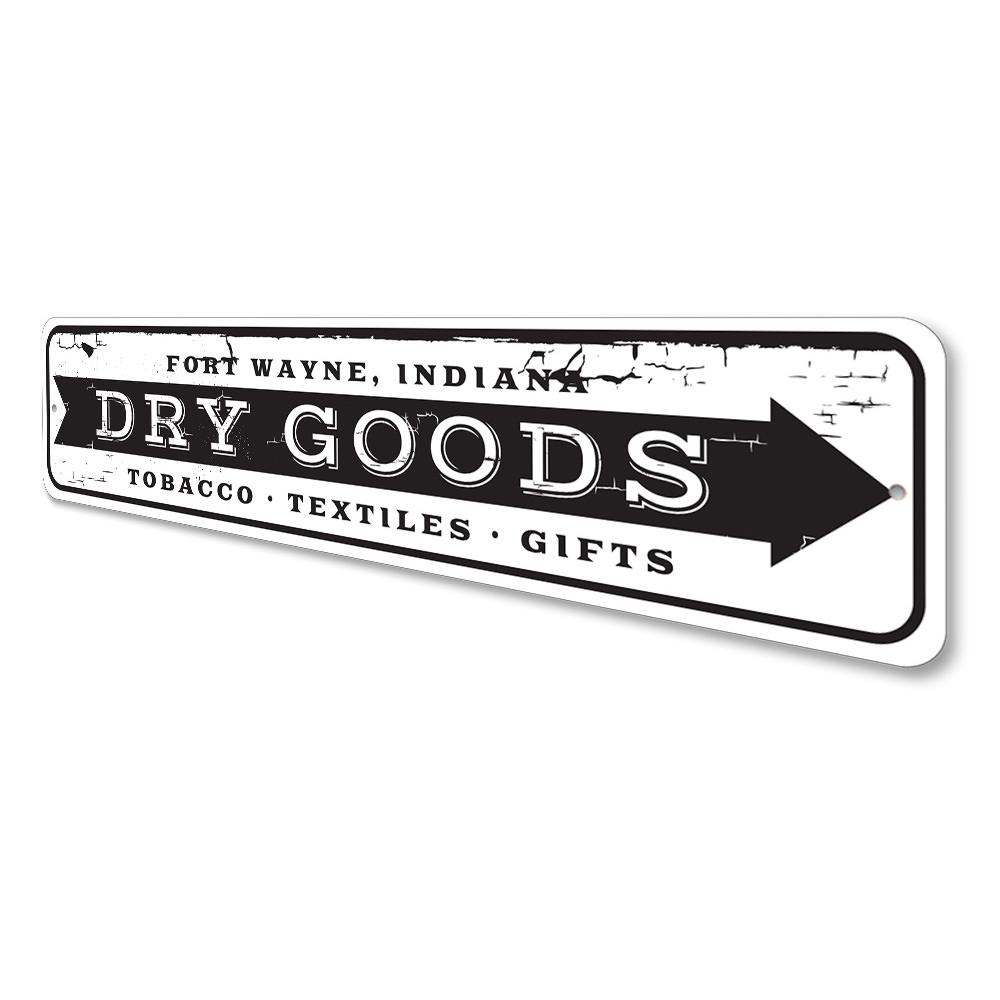 A decorative Dry Goods Arrow Sign made of high-quality aluminum, featuring customizable text and pre-drilled holes for easy mounting.