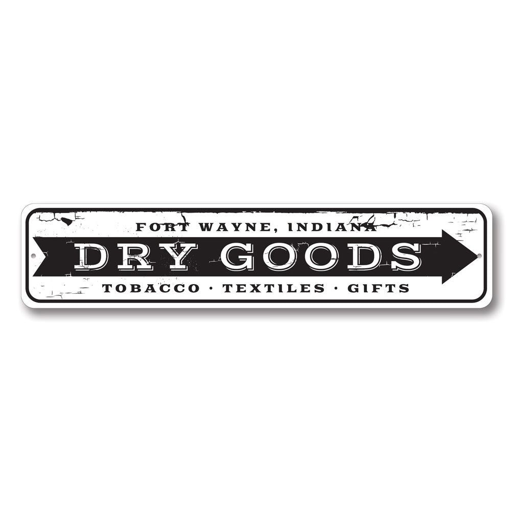 A decorative Dry Goods Arrow Sign made of high-quality aluminum, featuring customizable text and pre-drilled holes for easy mounting.