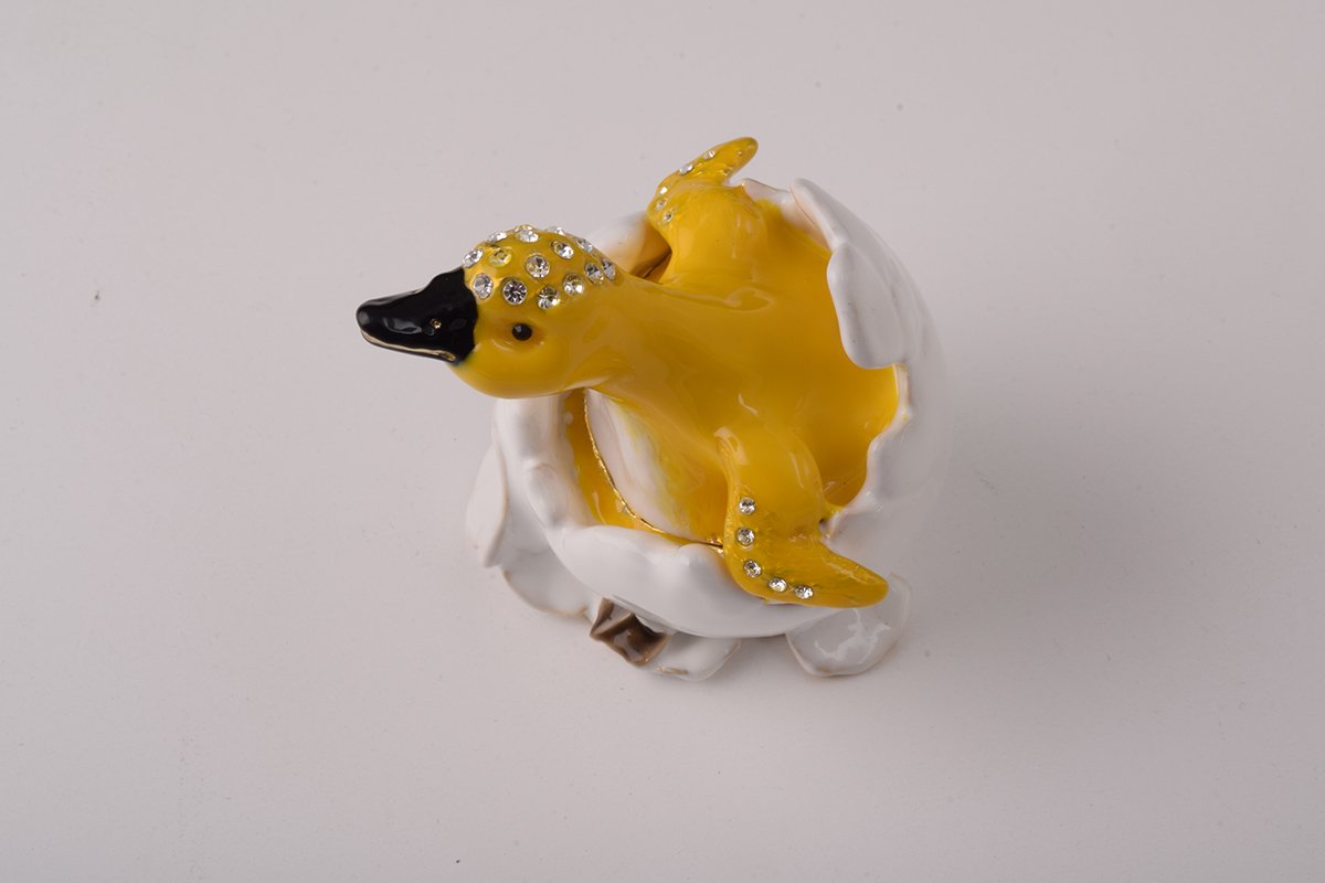 A beautifully crafted Duck trinket box emerging from an eggshell, adorned with Austrian crystals and plated with gold.