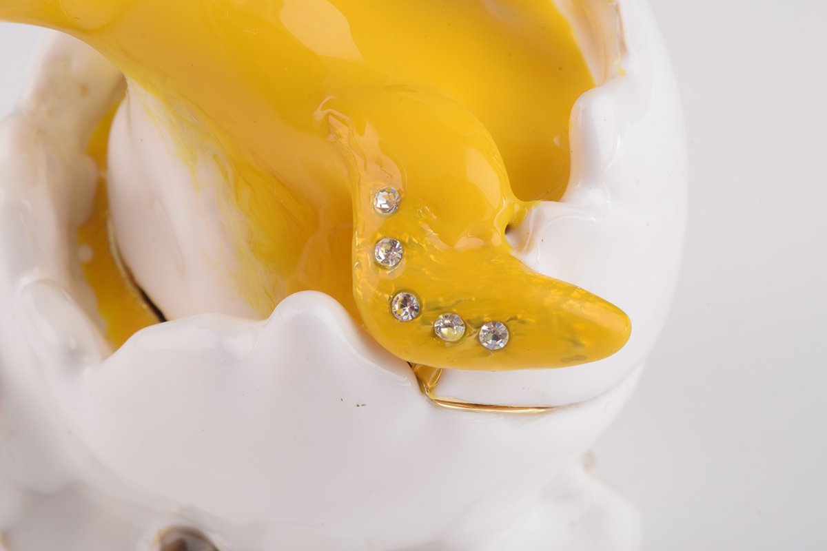 A beautifully crafted Duck trinket box emerging from an eggshell, adorned with Austrian crystals and plated with gold.